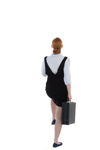 Female executive pretending to climb the steps — Stock Photo, Image