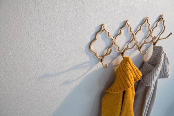 Warm clothes hanging on hook — Stock Photo, Image