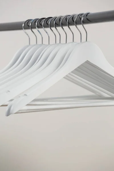 Hangers arranged on clothes rack — Stock Photo, Image