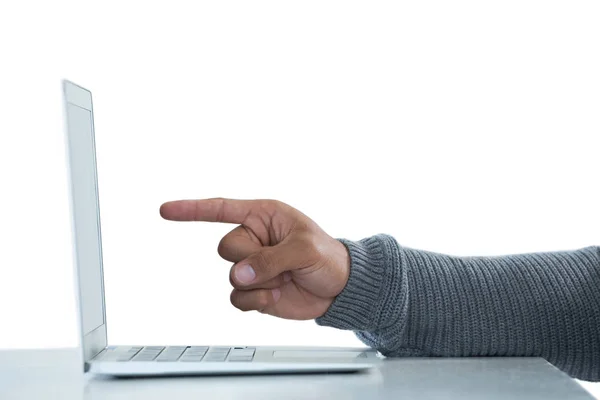 Male executive pointing towards laptop — Stock Photo, Image