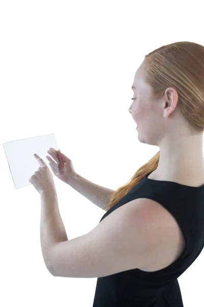 Female executive using glass digital tablet — Stock Photo, Image