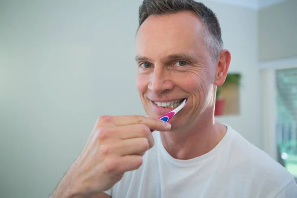 Hombre cepillándose los dientes con cepillo de dientes —  Fotos de Stock