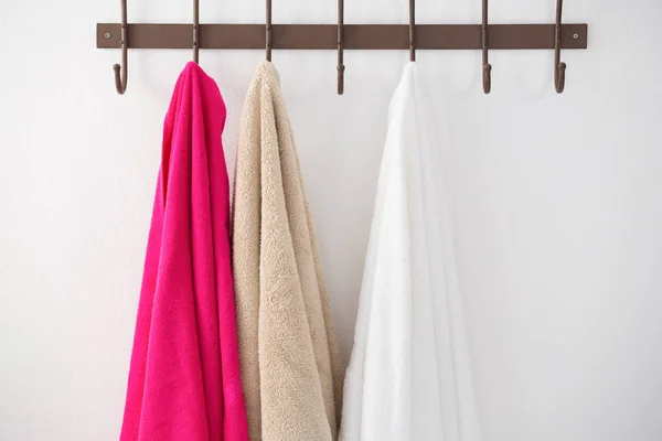 Colorful towels hanging on hook — Stock Photo, Image