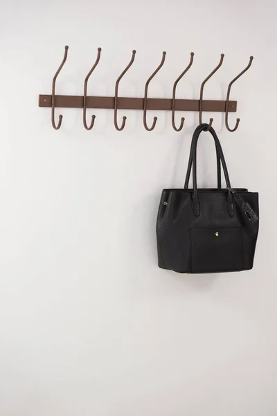 Black bag hanging on hook — Stock Photo, Image