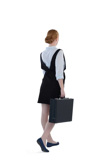 Female executive walking with suitcase — Stock Photo, Image