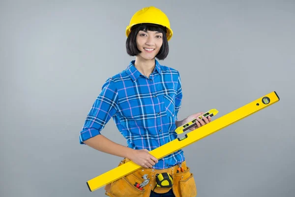 Female architect holding measuring equipment — Stock Photo, Image
