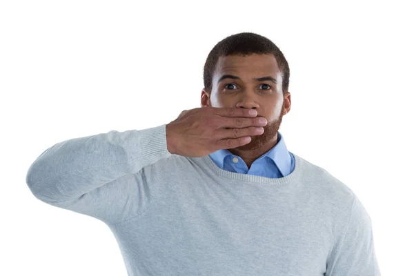 Male executive covering mouth with hand — Stock Photo, Image