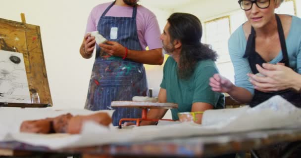 Profesor de dibujo asistiendo a artista en cerámica — Vídeos de Stock