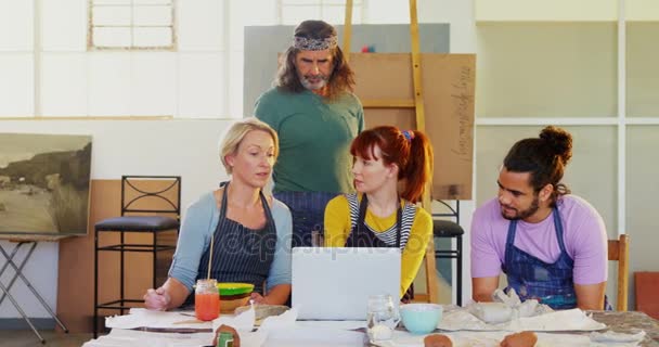 Artists using laptop at table — Stock Video