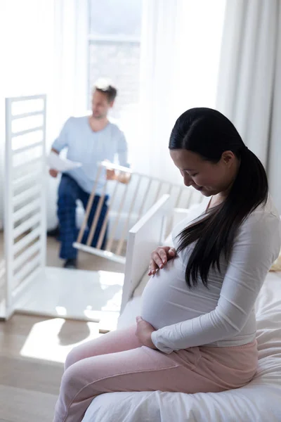 Woman feeling presence of baby in stomach — Stock Photo, Image