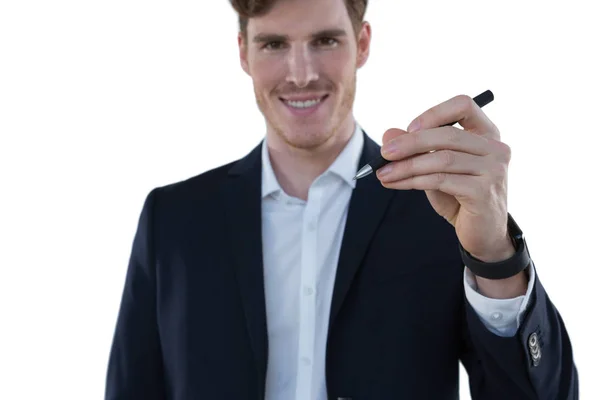 Businessman writing on an invisible screen — Stock Photo, Image