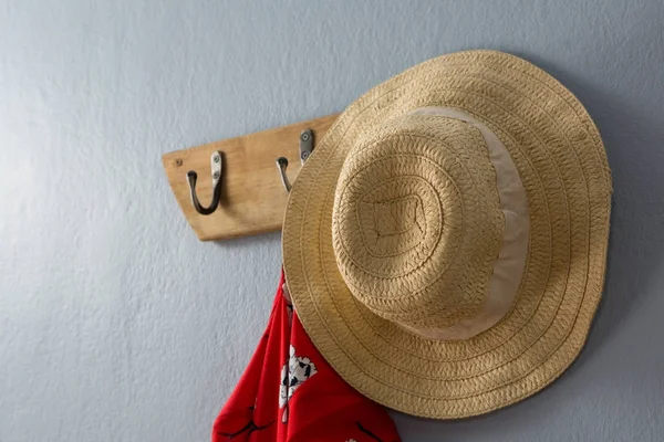 Dress and hat hanging on hook — Stock Photo, Image