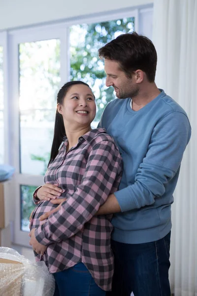 Man touching woman's pregnant belly — Stock Photo, Image