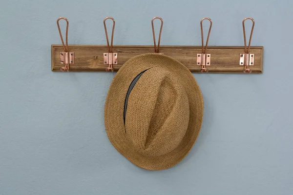 Straw hat hanging on hook — Stock Photo, Image