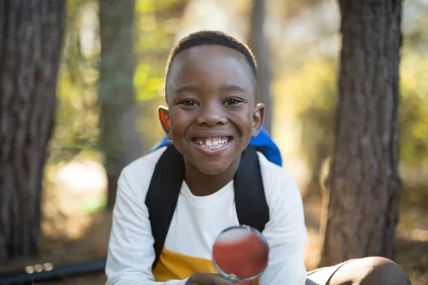 Boy holding magnifying glass — Stock Photo, Image