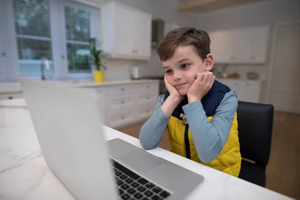 Cute boy looking at laptop — Stock Photo, Image