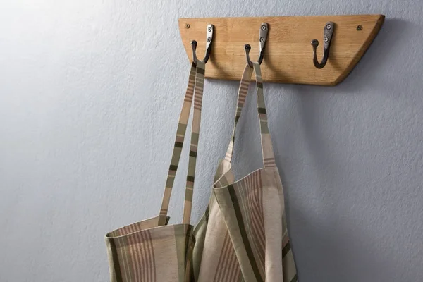 Aprons hanging on hook — Stock Photo, Image