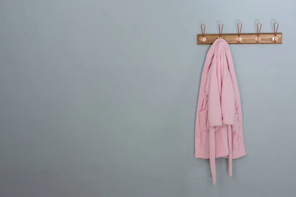 Bathrobes hanging on hook — Stock Photo, Image