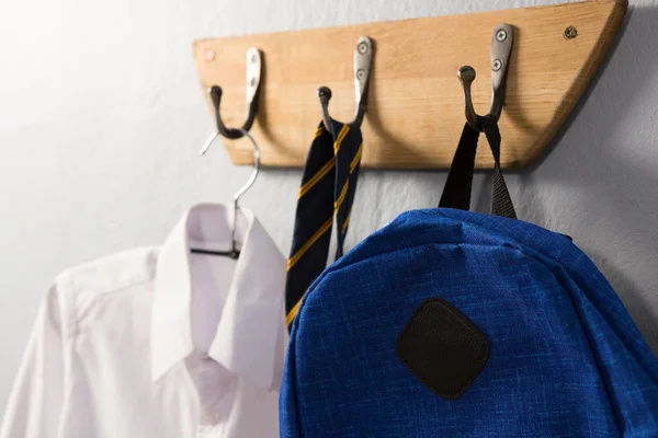 Schoolbag hanging on hook — Stock Photo, Image