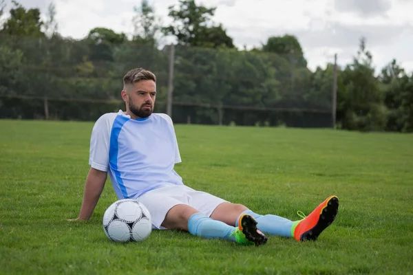 Giocatore di calcio rilassante nel terreno — Foto Stock