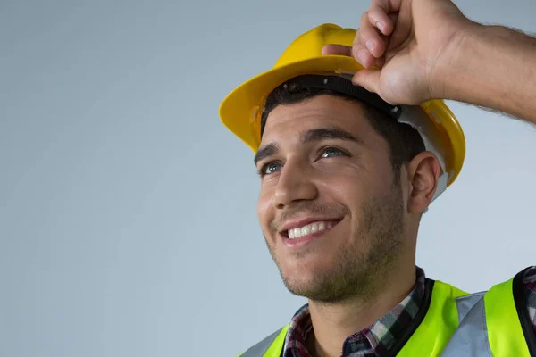 Male architect holding hard hat — Stock Photo, Image