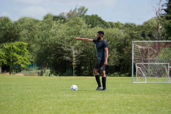 Football player standing with soccer — Stock Photo, Image