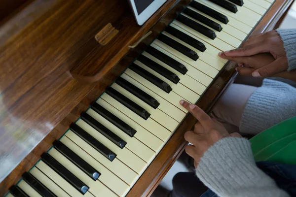 Mor medhjälpande dotter spela piano — Stockfoto