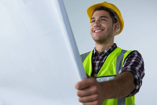 Male architect looking at blueprint — Stock Photo, Image