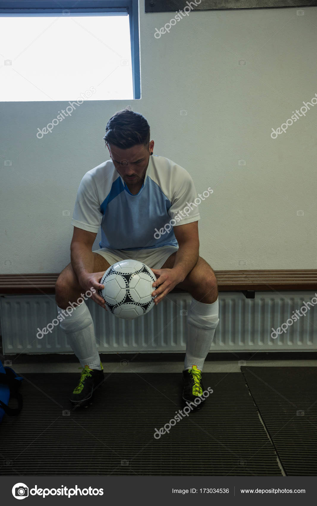 Football Player Sitting On Bench Stock Photo C Wavebreakmedia