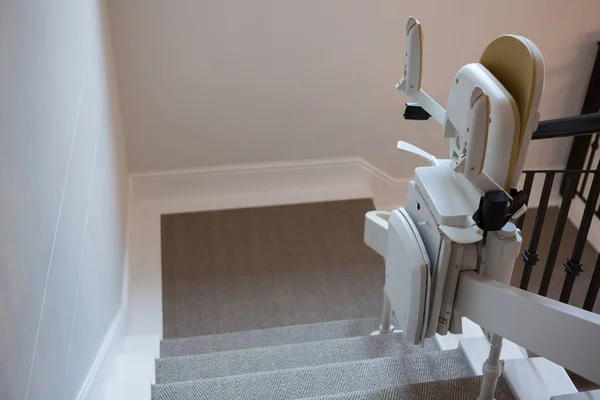 Close-up of stairlift on railing — Stock Photo, Image