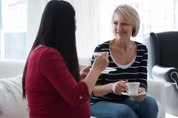 Female friends interacting with each other — Stock Photo, Image