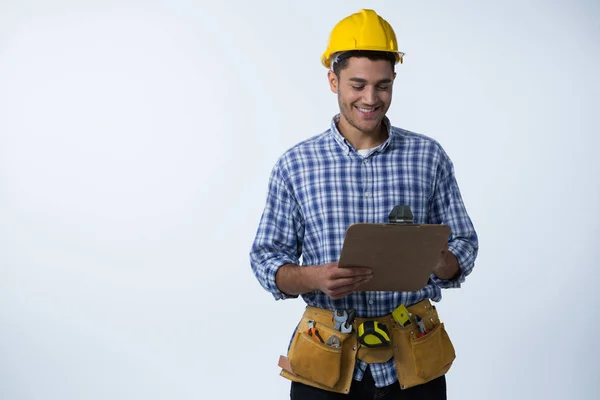 Male architect looking at clipboard — Stock Photo, Image