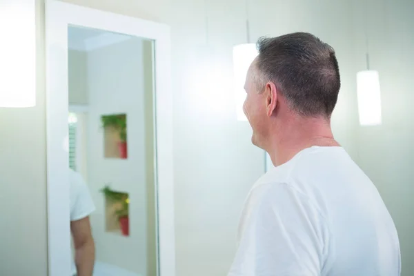 男人看着浴室里的镜子 — 图库照片