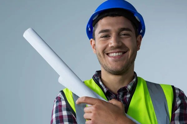 Male architect holding blueprint — Stock Photo, Image