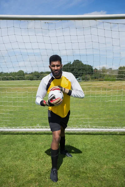 Goalkeeper holding football — Stock Photo, Image