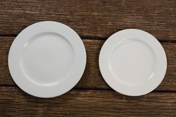 Placas brancas na mesa de madeira — Fotografia de Stock