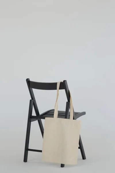 Grocery bag hanging on black chair — Stock Photo, Image