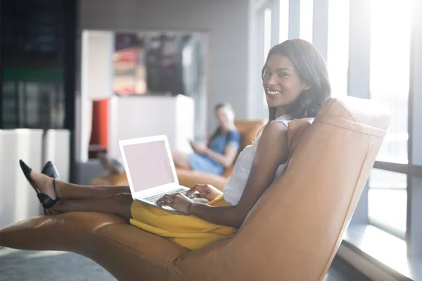 Female executive using laptop — Stock Photo, Image