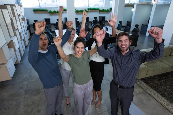 Business colleagues standing with arms up — Stock Photo, Image