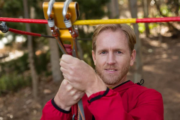 Hiker man holding zip line pulley — Stock Photo, Image