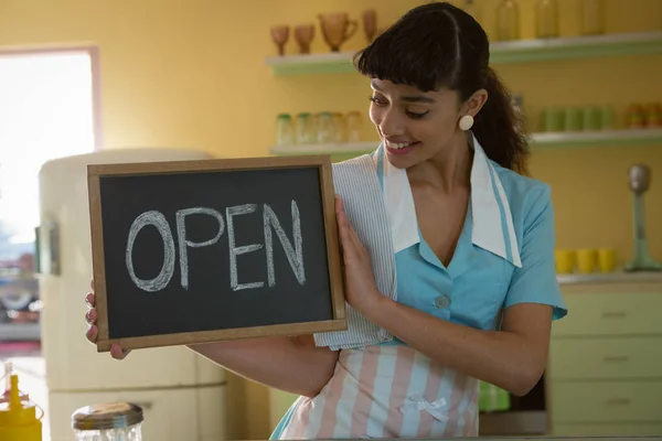 Waitress showing slate with open sign — Stock Photo, Image