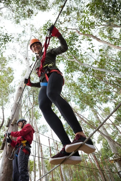 woman crossing zip line