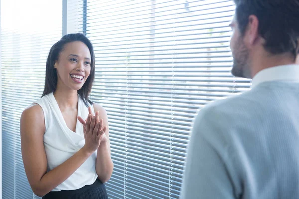 Male and female executives interacting — Stock Photo, Image