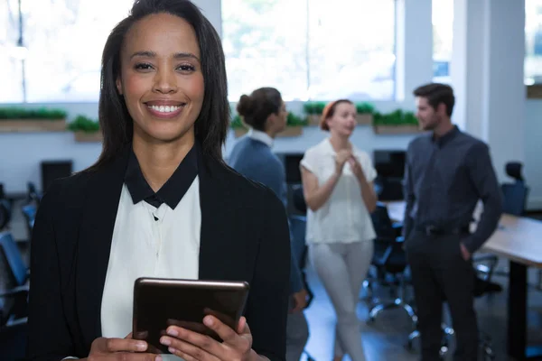 Female executive using digital tablet in office — Stock Photo, Image