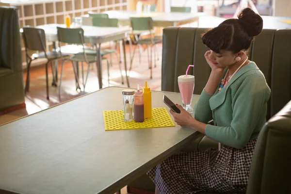 Vrouw zittend op de Bank met behulp van de telefoon — Stockfoto