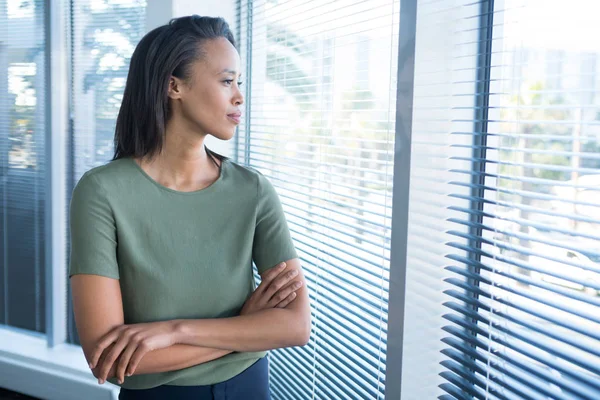 Female executives looking through window — Stock Photo, Image