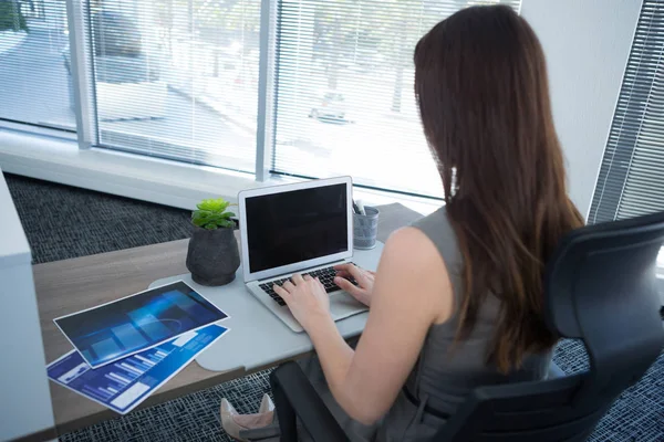 Rear view of female executive using laptop — Stock Photo, Image