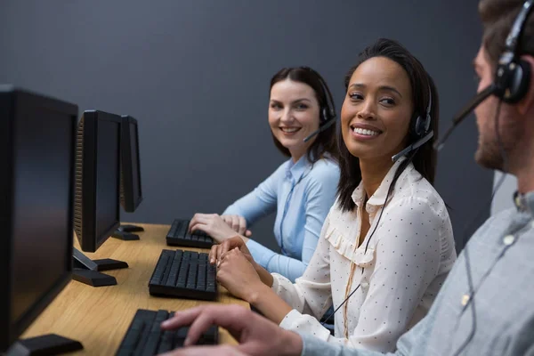 Şirket yöneticileri bilgisayarları kullanan kulaklık ile — Stok fotoğraf