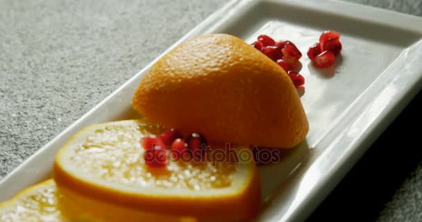 Close Slice Orange Pomegranate Seeds Tray Grey Background — Stock Video