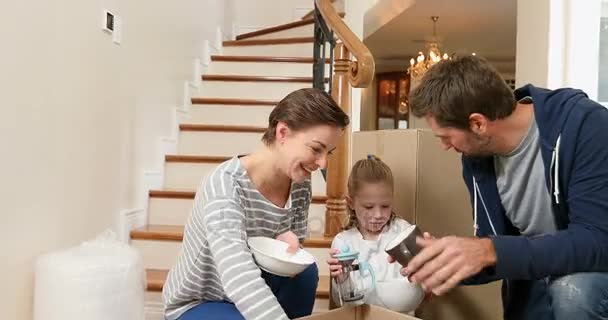 Happy Family Unpacking Cardboard Boxes New Home — Stock Video